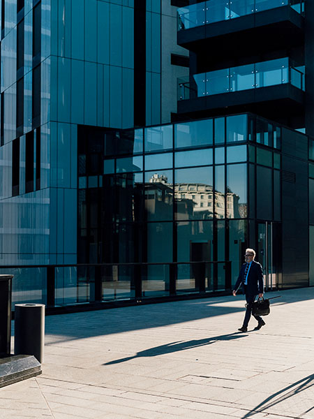 Businessman walking with-briefcase outside office